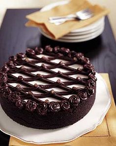 a chocolate cake sitting on top of a white plate