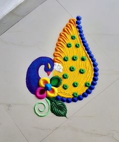 a decorated peacock on the ground with buttons