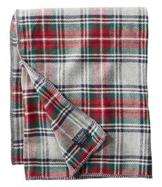 a plaid blanket folded on top of a white background