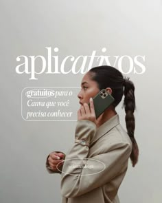 a woman talking on a cell phone while standing in front of a wall with the words applicativos above her head