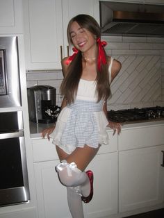 a young woman is posing in the kitchen