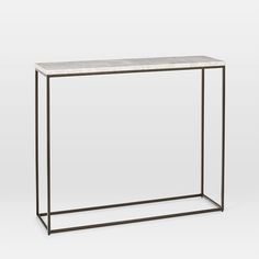 a white marble top and metal frame console table with an open shelf on one side