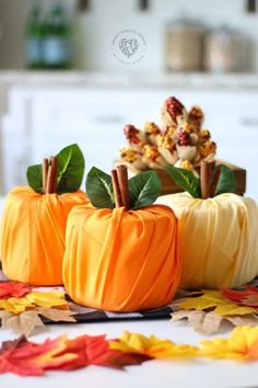 three small pumpkins sitting on top of a table