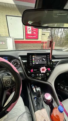 the interior of a car with various items on the dashboard and in front of it