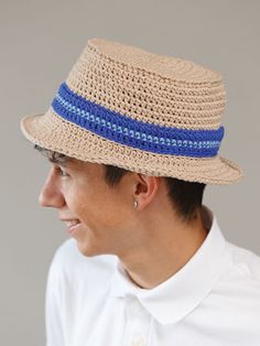 a man wearing a straw hat with blue stripes