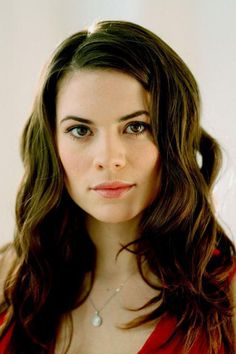 a woman in a red dress posing for the camera