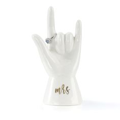 a white ceramic ring holder with the word mr and mrs on it's fingers