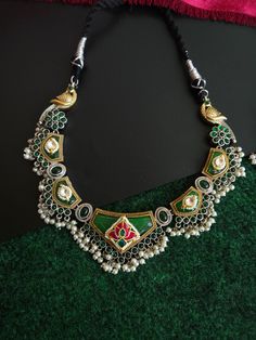 Antique silver replica necklace in Contemporary Look. Fusion Jewellery. Most demanding and liked necklace with beautiful color. Traditional Indian jewelry necklace. Add charm and charisma to your beautiful personality with these stunningly handcrafted silver look alike pendand necklace . Wear it with any of your formal or casual outfits and grab compliments all the way!