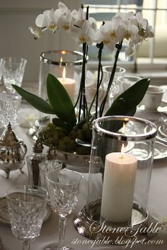 the centerpiece is decorated with white flowers and candles