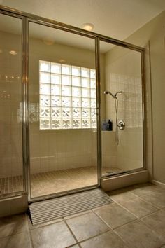 a walk in shower sitting inside of a bathroom