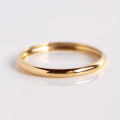 The perfect, dainty solid gold band! The 14k Delicate Yellow Gold Wedding Band by Carried Jewels for a feminine take on a classic band. Shop more environmentally friendly wedding rings at Local Eclectic. Delicate 14k Gold Band, Simple 14k Yellow Gold Bands, Delicate 14k Yellow Gold Bands, Minimalist Recycled Gold Yellow Bands, Classic Wedding Bands With Simple Design, Minimalist Yellow Gold Wedding Ring With Smooth Bezel, Classic Gold Stackable Rings, Classic Yellow Gold Bands With Simple Design, Minimalist Yellow Gold Band With Simple Design