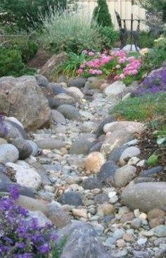 a garden with rocks and flowers in it