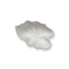 a white leaf shaped dish on a white background