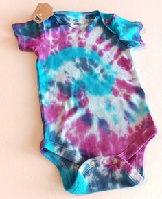 Tie Dye Baby Body Suit , Colorful Baby T Shirt With 3 Snap Crotch Blue Pink Purple Swirls Size 12-18 Months , Summer Baby One Piece   Baby will look and feel cool this Summer in this adorable cotton one piece bodysuit that was hand dyed using colors including aqua blue  ,  indigo , purple , and pink. Super cute short sleeved shirt for baby has a three snap closure at the crotch for easier dressing and diaper changes. This one piece snap shut top is infants size 12-18 Months . Bodysuit has been w Tie Dye Tops, Colorful Baby, Small Business Gifts, Purple Swirl, Blue Pink Purple, Big Gifts, Baby Colors, Baby T Shirts, One Piece Bodysuit