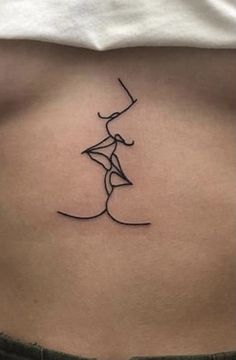 a woman's stomach with a small tattoo on it