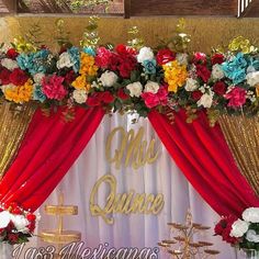 a wedding stage decorated with flowers and gold lettering that says mrs quince as the backdrop