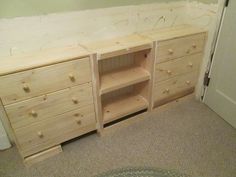 a wooden dresser sitting in the corner of a room