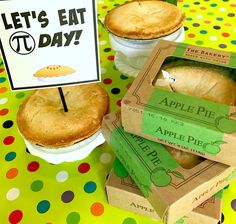 apple pies are sitting in boxes on a polka dot tablecloth with a sign that says let's eat to day