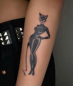 a woman with a cat tattoo on her arm