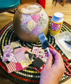 a person is cutting fabric with scissors on a table