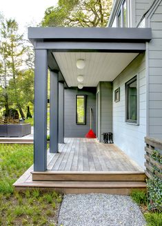 a house with a wooden deck in the front yard