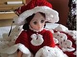 the doll is wearing a red and white crocheted outfit