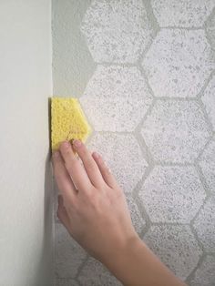 a person is cleaning the wall with a sponge