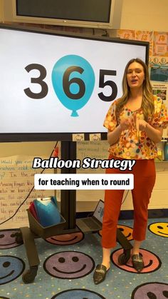 a woman standing in front of a sign with balloons on it and the caption balloon strategy for teaching when to round