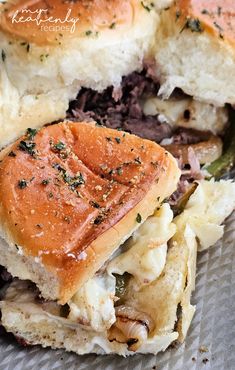 a close up of a sandwich on a piece of tin foil with meat and cheese