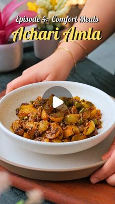 a person holding a bowl of food with the words episode 3 comfort meals alhaj amla