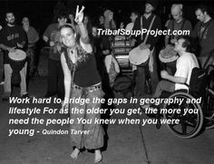 a woman standing in front of a group of people holding up two peace signs with the words work hard to bridge the gaps in geography and freestyle