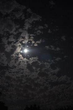 the moon is shining brightly in the night sky