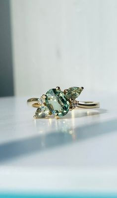 three stone ring sitting on top of a table