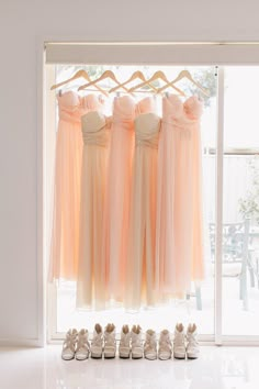 the bridesmaids'dresses and shoes are lined up in front of an open window