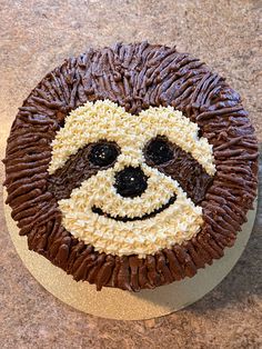 a cake decorated like a smiling face with chocolate icing