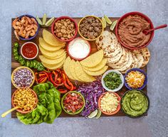 a platter filled with tacos, salsa and tortilla chips