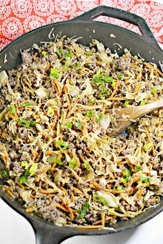 a skillet filled with ground beef and vegetables