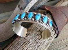 7 ROW TURQUOISE BRACELET, Signed by the artist, "F. Peters" with a broken arrow symbol which is the hallmark of Fred Peters renowned Navajo artist..Also, Stamped "Sterling"Size 6 1/2" inside circumference including a 1 1/16" gap.35.5 Grams3/4-13/16" WidePre-owned in excellent vintage condition. Some Patina But no damage.Ships USPS Priority Insured Mail Arrow Symbol, Southwestern Turquoise Inlay Sterling Silver Bracelet, Unique Turquoise Nickel-free Bracelets, Southwestern Style Turquoise Hand-strung Jewelry, Southwestern Turquoise Hand-strung Bracelets, Broken Arrow, Navajo Bracelet, One-of-a-kind Southwestern Turquoise Jewelry, Vintage Navajo