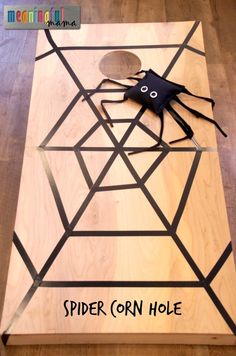 a wooden table topped with a spider on top of it