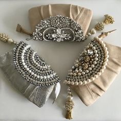 three pieces of beaded jewelry sitting on top of a white table next to each other