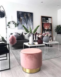 a living room filled with lots of furniture and plants on top of it's tables