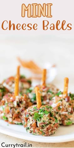 mini cheese balls on a white plate with carrot sticks sticking out of the top one