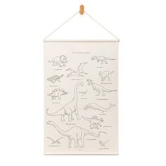 a white wall hanging with dinosaurs on it