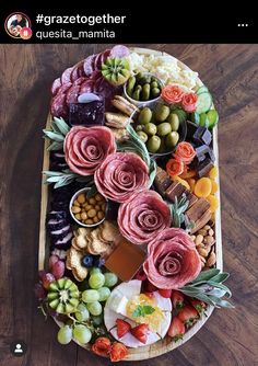 a platter filled with lots of different types of food on top of a wooden table