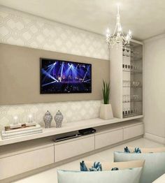 a living room filled with furniture and a flat screen tv mounted to the side of a wall