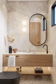 a bathroom with a wooden bench and mirror