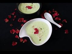 two bowls filled with soup and rose petals