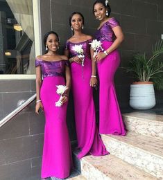 three women in purple dresses posing for the camera