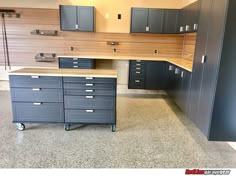 an empty garage with lots of drawers and cabinets