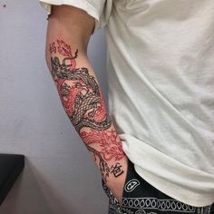 a man with a dragon tattoo on his arm